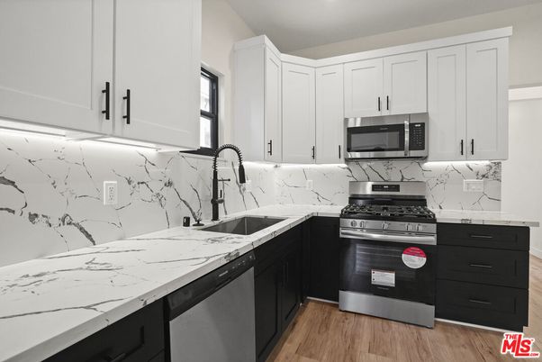 Interior, Kitchen, Marble Walls, Recessed Lighting, Stainless Steel Appliances, Wood Texture Flooring