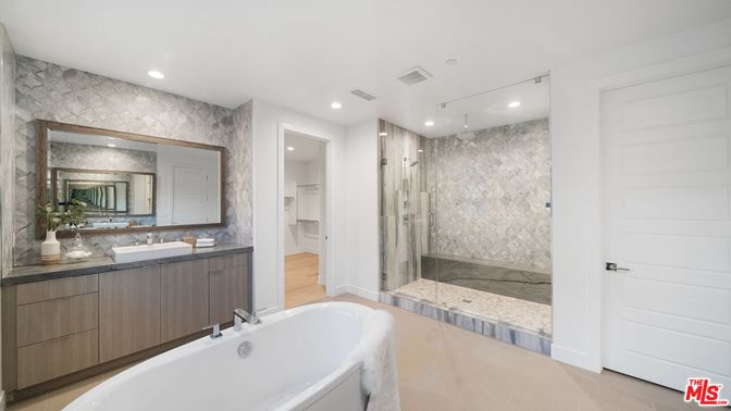 Bathroom, Dual Sink Vanities, Free Standing Baths, Glass Shower, Interior, Marble Walls, Recessed Lighting, Wood Texture Flooring