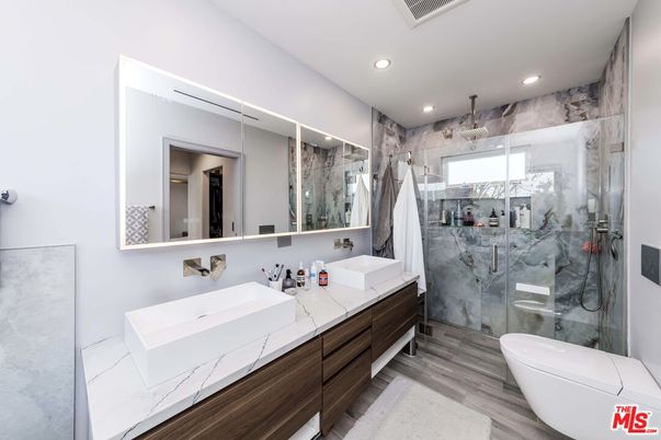 Bathroom, Dual Sink Vanities, Glass Shower, Interior, Marble Walls, Recessed Lighting, Wood Texture Flooring