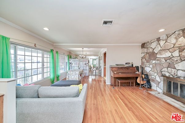 Chandelier, Fireplace, Interior, Piano, Recessed Lighting, Stone Walls, Wood Texture Flooring