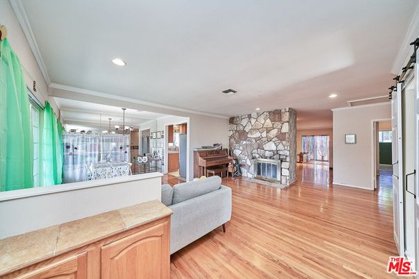 Fireplace, Interior, Pendant Lights, Piano, Recessed Lighting, Stone Walls, Wood Texture Flooring