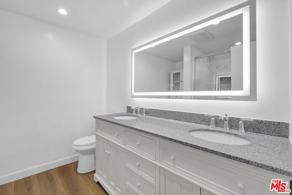 Bathroom, Dual Sink Vanities, Glass Shower, Interior, Recessed Lighting, Wood Texture Flooring