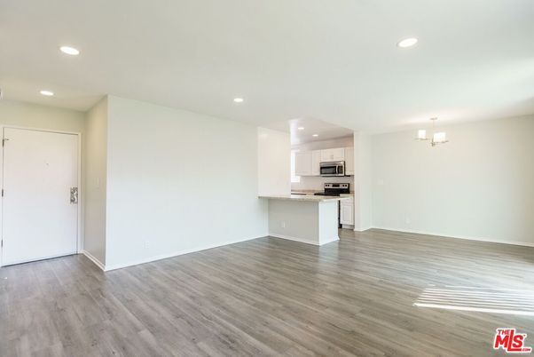 Chandelier, Empty room, Interior, Kitchen, Recessed Lighting, Stainless Steel Appliances, Wood Texture Flooring