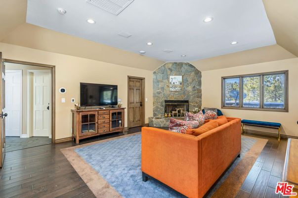 Fireplace, Interior, Living room, Recessed Lighting, Stone Walls, Wood Texture Flooring