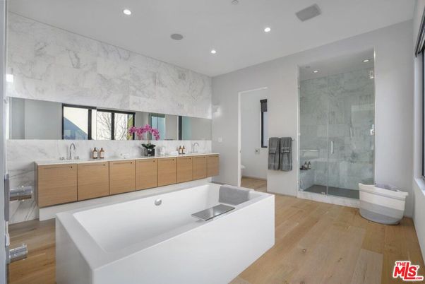 Bathroom, Dual Sink Vanities, Glass Shower, Interior, Marble Walls, Recessed Lighting, Wood Texture Flooring