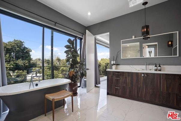 Bathroom, Dual Sink Vanities, Free Standing Baths, Interior, Marble, Marble Walls, Pendant Lights, Recessed Lighting