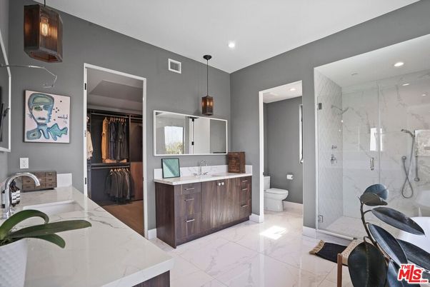 Bathroom, Dual Sink Vanities, Glass Shower, Interior, Marble, Marble Walls, Pendant Lights, Recessed Lighting