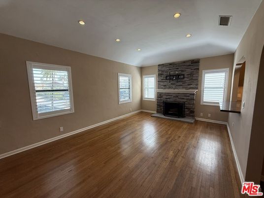 Empty room, Fireplace, Interior, Recessed Lighting, Stone Walls, Wood Texture Flooring