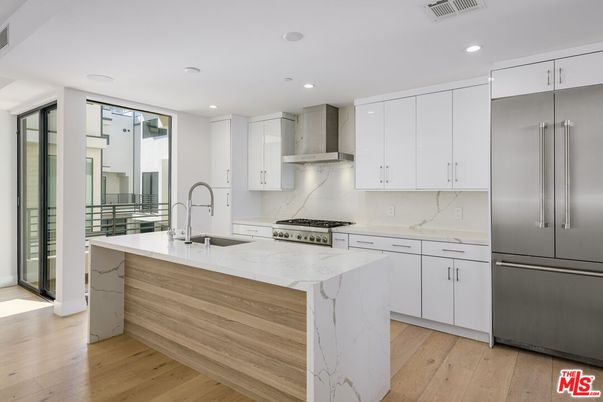 Interior, Kitchen, Marble Walls, Recessed Lighting, Stainless Steel Appliances, Wood Texture Flooring