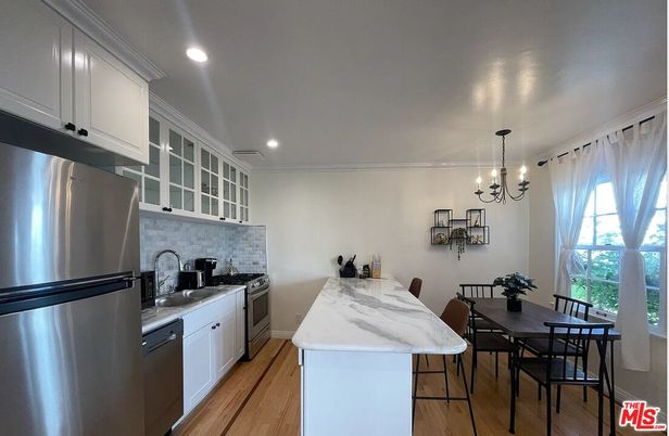Chandelier, Dining room, Interior, Kitchen, Pendant Lights, Recessed Lighting, Stainless Steel Appliances, Wood Texture Flooring