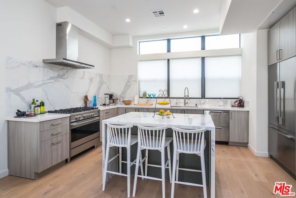 Interior, Kitchen, Marble Walls, Recessed Lighting, Stainless Steel Appliances, Wood Texture Flooring