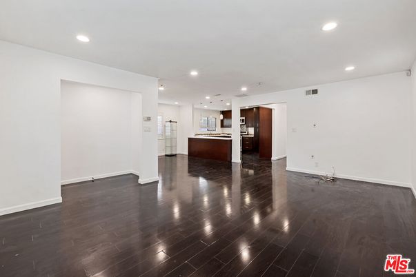 Empty room, Interior, Kitchen, Recessed Lighting, Stainless Steel Appliances, Wood Texture Flooring