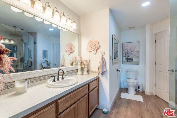 Bathroom, Glass Shower, Interior, Recessed Lighting, Tile Countertops, Wood Texture Flooring