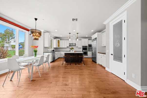 Chandelier, Dining room, Interior, Kitchen, Pendant Lights, Recessed Lighting, Stainless Steel Appliances, Wood Texture Flooring