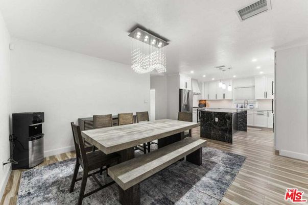 Chandelier, Dining room, Interior, Kitchen, Pendant Lights, Recessed Lighting, Stainless Steel Appliances, Wood Texture Flooring