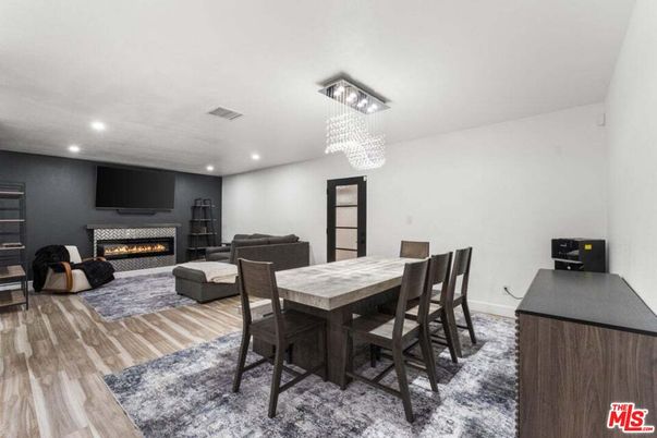 Chandelier, Dining room, Fireplace, Interior, Living room, Pendant Lights, Recessed Lighting, Wood Texture Flooring