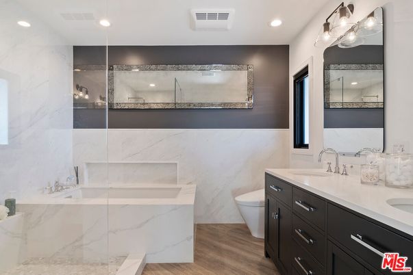 Bathroom, Dual Sink Vanities, Glass Shower, Interior, Marble Walls, Recessed Lighting, Wood Texture Flooring