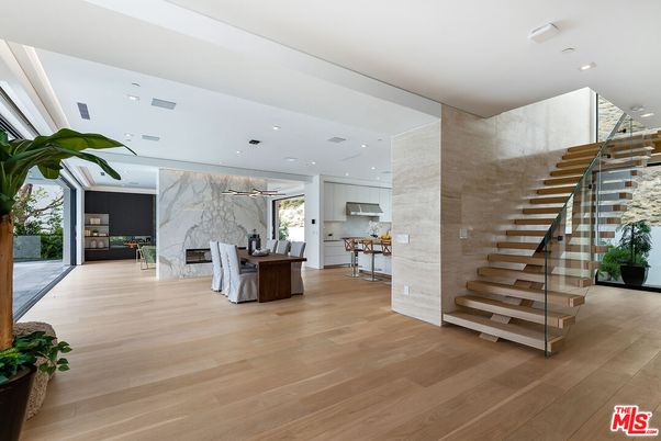 Fireplace, Interior, Kitchen, Marble Walls, Pendant Lights, Recessed Lighting, Stainless Steel Appliances, Wood Texture Flooring