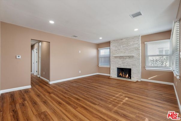 Empty room, Fireplace, Interior, Recessed Lighting, Stone Walls, Wood Texture Flooring
