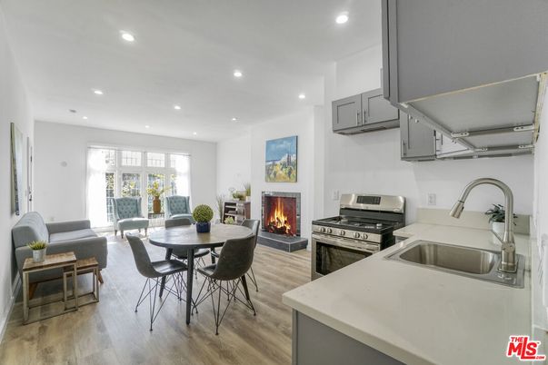Dining room, Fireplace, Interior, Kitchen, Living room, Recessed Lighting, Stainless Steel Appliances, Wood Texture Flooring
