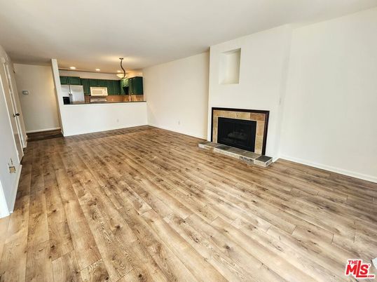 Empty room, Fireplace, Interior, Kitchen, Pendant Lights, Recessed Lighting, Wood Texture Flooring