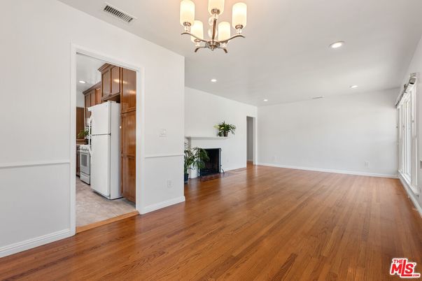 Chandelier, Empty room, Fireplace, Interior, Kitchen, Recessed Lighting, Wood Texture Flooring