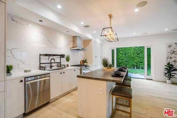 Interior, Kitchen, Marble Walls, Pendant Lights, Recessed Lighting, Stainless Steel Appliances, Wood Texture Flooring