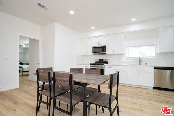 Dining room, Interior, Kitchen, Recessed Lighting, Stainless Steel Appliances, Wood Texture Flooring
