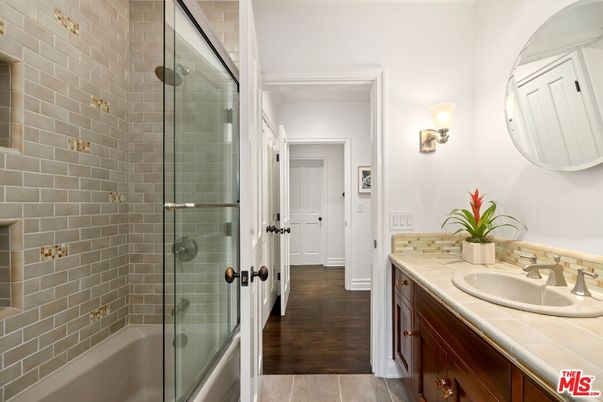 Bathroom, Dual Sink Vanities, Glass Shower, Interior, Stone Walls, Tile Countertops, Wood Texture Flooring