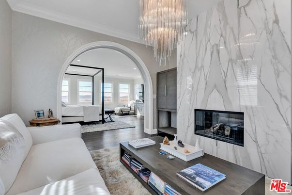 Chandelier, Fireplace, Interior, Living room, Marble Walls, Recessed Lighting, Wood Texture Flooring