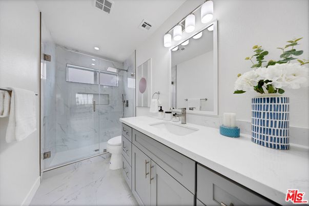 Bathroom, Dual Sink Vanities, Glass Shower, Interior, Marble, Marble Walls, Recessed Lighting