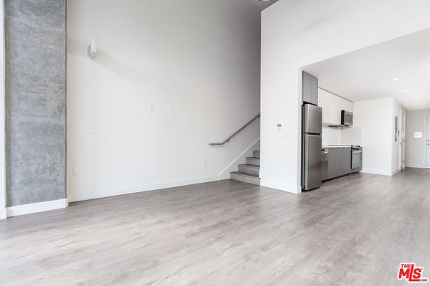 Empty room, Interior, Kitchen, Recessed Lighting, Stainless Steel Appliances, Wood Texture Flooring