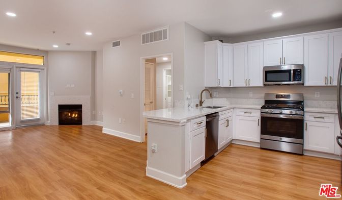 Fireplace, Interior, Kitchen, Recessed Lighting, Stainless Steel Appliances, Wood Texture Flooring
