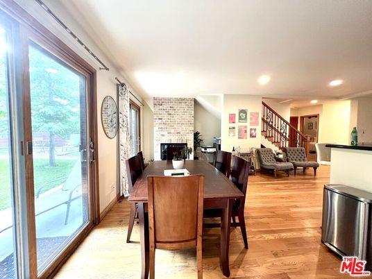 Dining room, Fireplace, Interior, Living room, Recessed Lighting, Stone Walls, Wood Texture Flooring