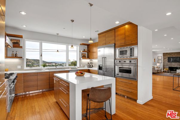 Fireplace, Interior, Kitchen, Pendant Lights, Recessed Lighting, Stainless Steel Appliances, Stone Walls, Wood Texture Flooring