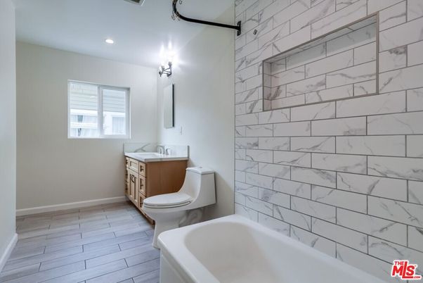 Bathroom, Dual Sink Vanities, Interior, Marble Walls, Recessed Lighting, Wood Texture Flooring