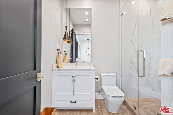 Bathroom, Glass Shower, Interior, Marble Walls, Recessed Lighting, Wood Texture Flooring