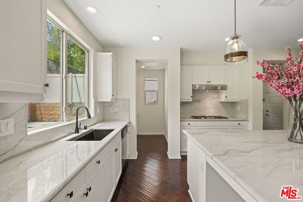 Interior, Kitchen, Marble Walls, Pendant Lights, Recessed Lighting, Stainless Steel Appliances, Wood Texture Flooring