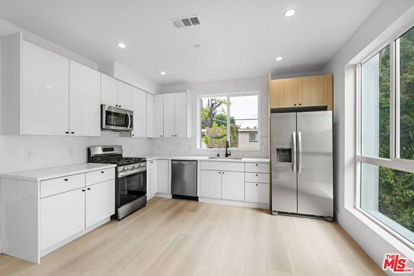 Interior, Kitchen, Marble Walls, Recessed Lighting, Stainless Steel Appliances, Wood Texture Flooring