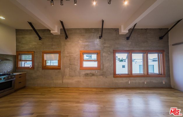 Empty room, Interior, Kitchen, Recessed Lighting, Stainless Steel Appliances, Wood Texture Flooring