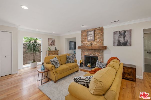 Fireplace, Interior, Living room, Recessed Lighting, Stone Walls, Wood Texture Flooring
