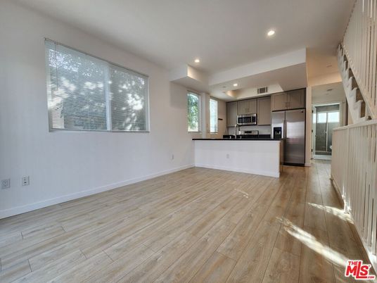 Empty room, Interior, Kitchen, Recessed Lighting, Stainless Steel Appliances, Wood Texture Flooring