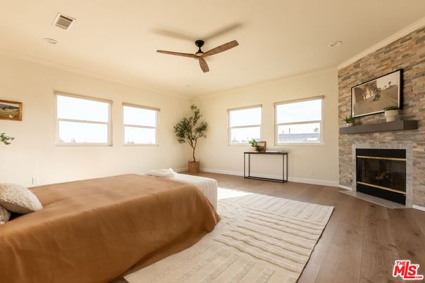 Bedroom, Fireplace, Interior, Recessed Lighting, Stone Walls, Wood Texture Flooring