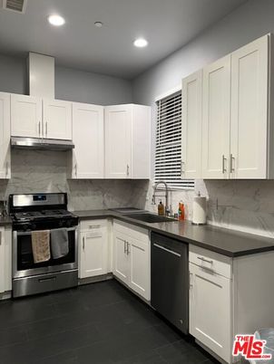 Interior, Kitchen, Marble Walls, Recessed Lighting, Stainless Steel Appliances