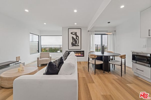 Dining room, Fireplace, Interior, Living room, Pendant Lights, Recessed Lighting, Wood Texture Flooring