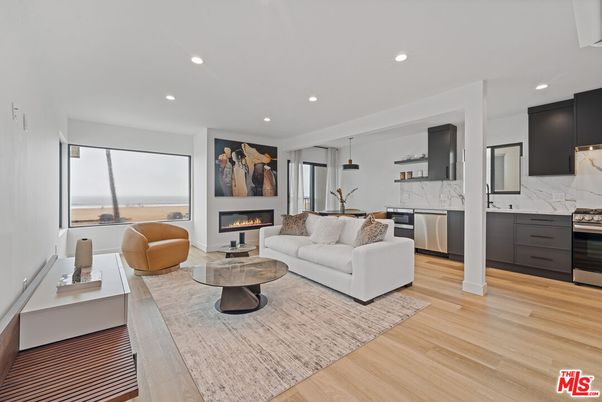 Fireplace, Interior, Kitchen, Living room, Marble Walls, Pendant Lights, Recessed Lighting, Stainless Steel Appliances, Water, Wood Texture Flooring