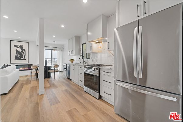 Fireplace, Interior, Kitchen, Living room, Recessed Lighting, Stainless Steel Appliances, Wood Texture Flooring
