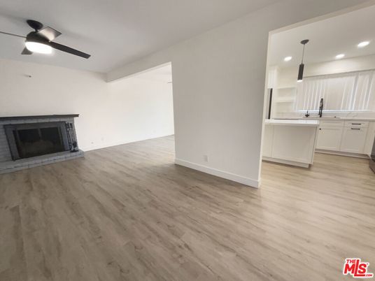 Empty room, Fireplace, Interior, Kitchen, Pendant Lights, Recessed Lighting, Wood Texture Flooring