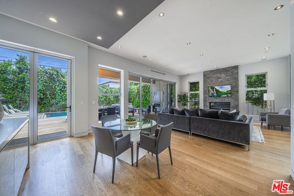 Dining room, Fireplace, Interior, Living room, Recessed Lighting, Stone Walls, Wood Texture Flooring