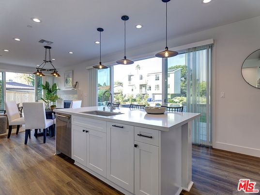 Dining room, Fireplace, Interior, Kitchen, Pendant Lights, Recessed Lighting, Stainless Steel Appliances, Wood Texture Flooring